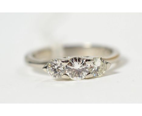 A platinum diamond three stone ring, graduated round brilliant cut diamonds in claw settings, total estimated diamond weight 