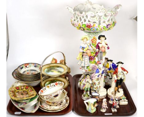 A floral encrusted figural centre piece; together with a group of Continental porcelain figures; Royal Crown Derby Imari dish