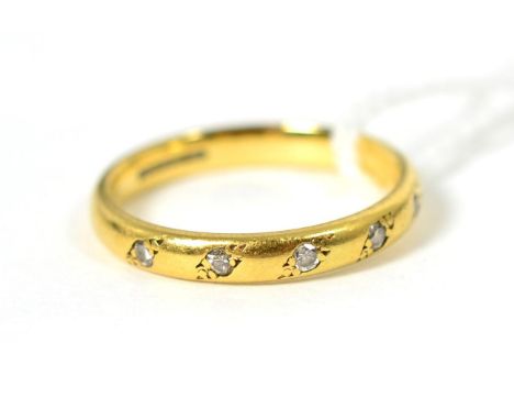 An 18 carat gold diamond half hoop ring, inset with five round brilliant cut diamonds, total estimated diamond weight 0.15 ca