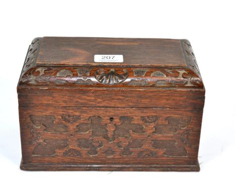 A carved oak two division tea caddy, with fitted interior 
