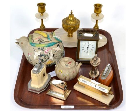 An onyx and gilt metal desk set comprising an inkwell and a pair of candlesticks; a desk calendar; four lighters/cigar cutter