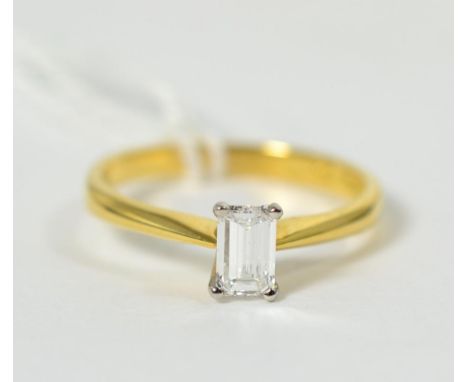 An 18 carat gold octagonal cut solitaire diamond ring, in a claw setting, to knife edge shoulders, estimated diamond weight 0