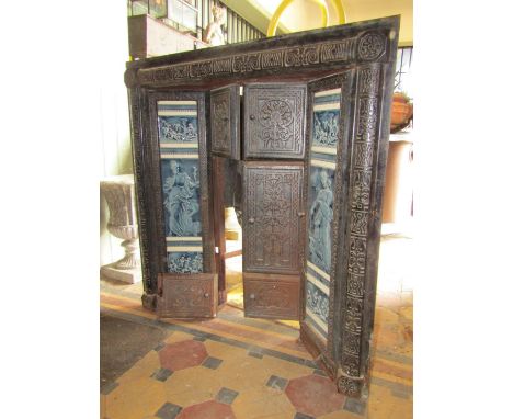 An aesthetic period cast iron fire surround with blue and white ceramic panel insets, further enclosed by three pairs of cast