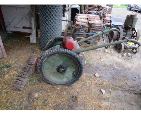 A vintage Allen scythe with petrol engine
