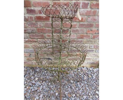 A Victorian wire work conservatory planter, circular, on two tiers, on scrolled supports, 105cm high, together with an ironwo