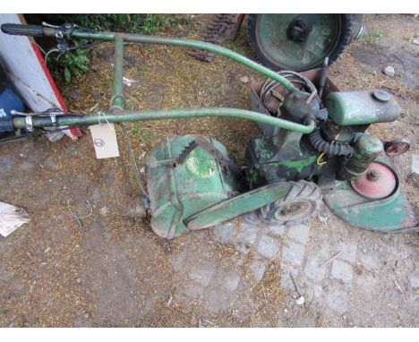 A vintage garden rotivator, petrol engine with additional grass mower and chainsaw attachments&nbsp;