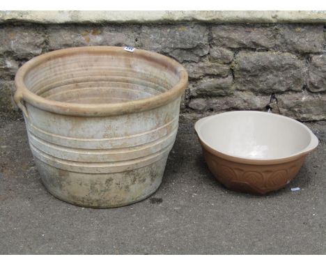 A simple terracotta planter and a small glazed kitchen mixing bowl 