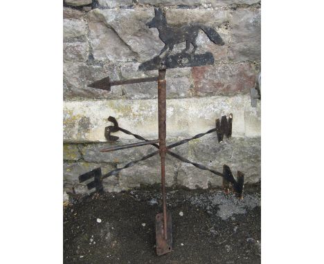 A weather vane surmounted by a fox 