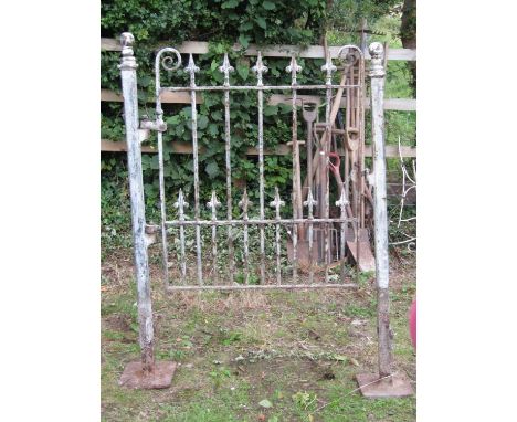 A Victorian iron pedestrian gate with spearhead and scrolled finials and square cut posts with ball finials, 110cm wide overa