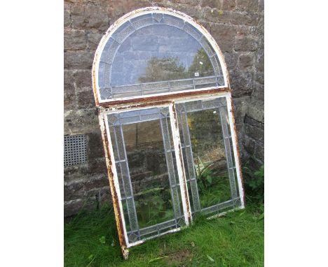 An art deco iron window frame with arched outline, with leaded light interior, 150cm high x 100cm wide 