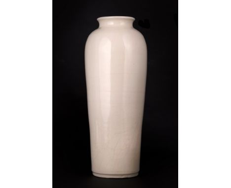   Slender in shape, it is completely covered with a light ivory glaze.  