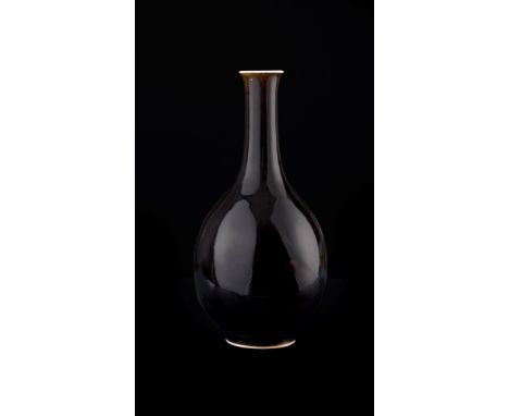   With an ovoid body, long narrow neck and flared rim, it is completely covered in a beautiful black glaze, except for the wh