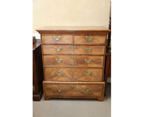 A Georgian figured walnut and feather banded chest on stand, the upper section fitted two small and three long graduated draw