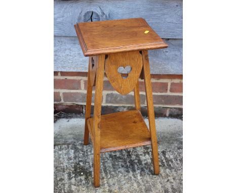 A light oak two-tier occasional table with pierced trefoil design, on square supports, 11" square x 23 1/2" high 