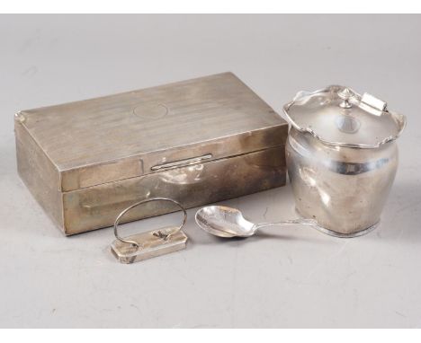 A silver cigarette box, a silver tea caddy, a silver caddy spoon with engraved decoration and a silver menu holder (damaged) 