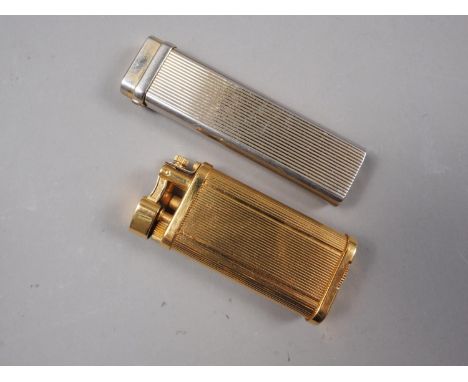 A Dunhill gold plated lighter, 2 1/2" long, and one other lighter 