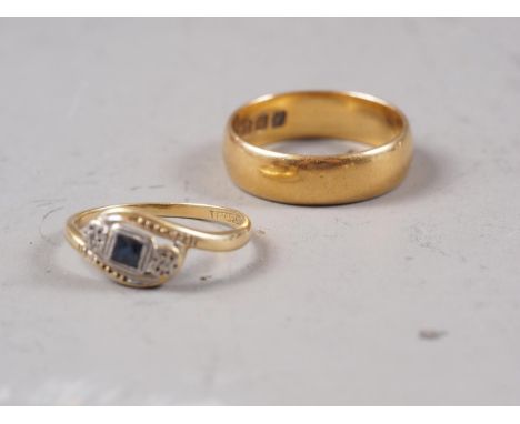 An 18ct gold, sapphire and diamond crossover ring, size J/K, 1.8g, and a 22ct gold wedding band, size N, 5.5g 