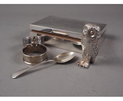 An engine turned cigarette box, two silver napkin rings, a silver teaspoon and a silver plated box, in the form of an owl 