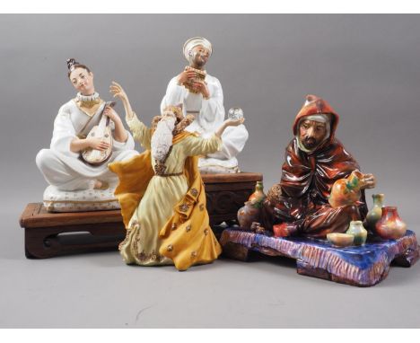 A Royal Doulton figure, "The Potter" HN1495, 7" high, a pair of bottles, formed as figures playing instruments, on carved woo