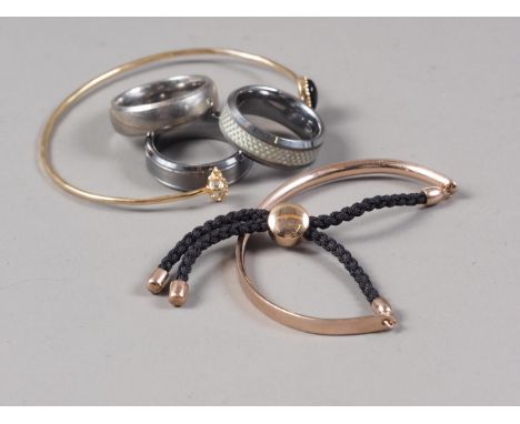 Two tungsten rings, a titanium ring, a Monica Vinader bangle and another bangle 