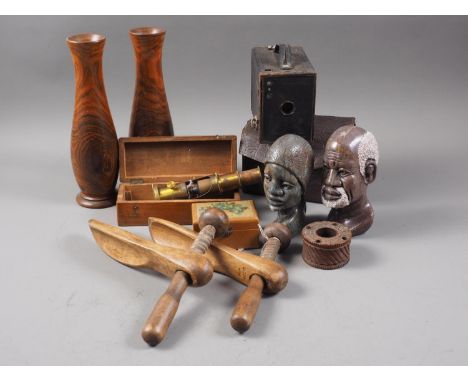 A pair of turned hardwood vases, 9 3/4" high, a carved wood inkwell, a pair of shoe lasts, a brass microscope, in case, a car