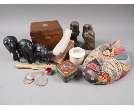 Three carved ebony elephants, in sizes, a carved hardwood painted Indonesian Garuda mask, a pewter inlaid tea caddy and other