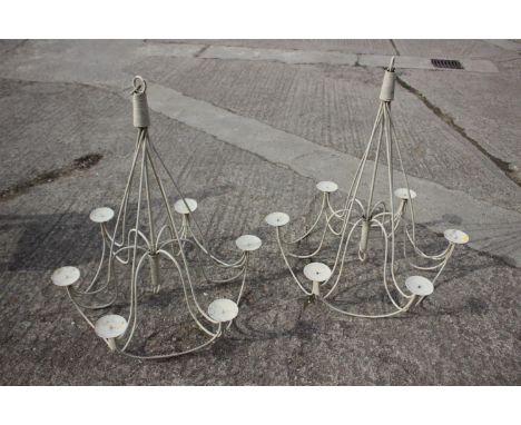 A pair of cream painted wrought iron six-light candelabra 