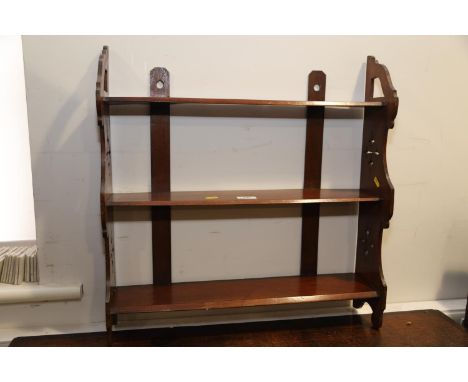 A late 19th century mahogany three-tier open wall shelf with Gothic pierced side panels, 22" wide x 5" deep x 22 1/2" high 