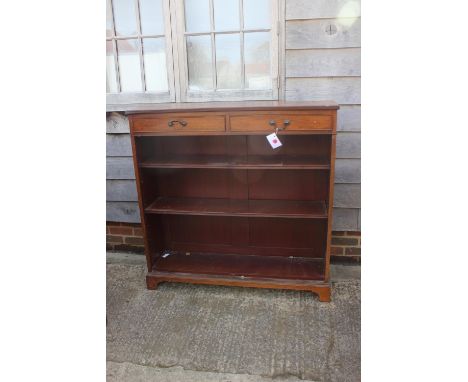 A Maples late 19th century walnut bookcase, fitted two drawers over open shelves, on bracket feet, 48" wide x 13" deep x 48" 