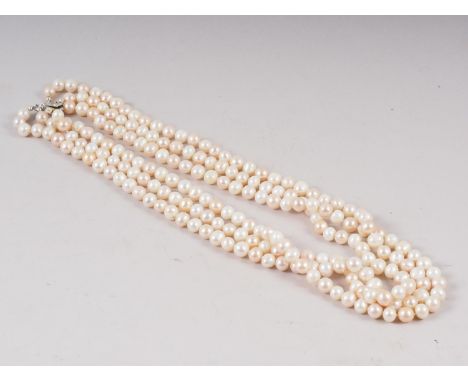 A three-strand cultured pearl necklace with white metal box clasp, stamped 925, 8mm approx average dia, 24" approx average le