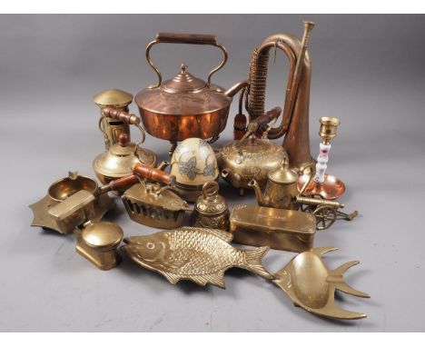 A brass and copper bugle, a copper kettle, two brass teapots with engraved decoration and other items 
