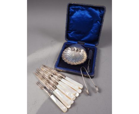 A set of silver bladed and mother-of-pearl handled fruit knives and forks, a silver shell-shaped butter dish and knife, in ca