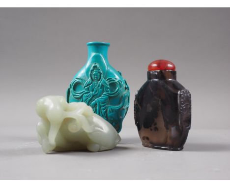 A turquoise composition snuff bottle with deity decoration (lacking top), a hardstone snuff bottle (damages) and a jade model