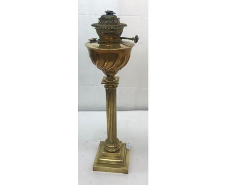 A brass oil lamp with Corinthian columns