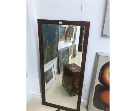 A large Victorian full-length mirror in oak-framed edging