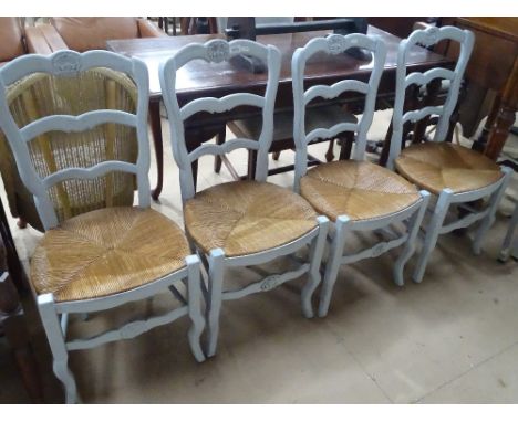 Pair of French painted ladder back and rush seated dining chairs.