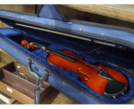 A violin and bow in fitted case.