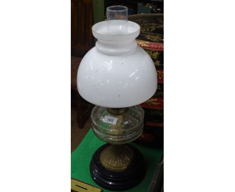 Antique oil lamp with glass font and glass shade.
