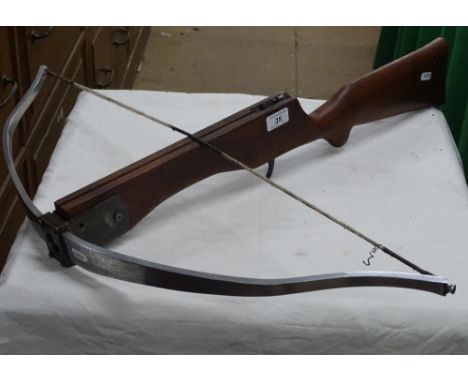 A cross bow and 2 arrows.
