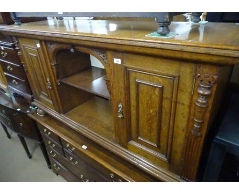 An Antique oak low sideboard with open shelf and panelled cupboards, on bun feet, length 5'1", height 2'8", depth 1'4".