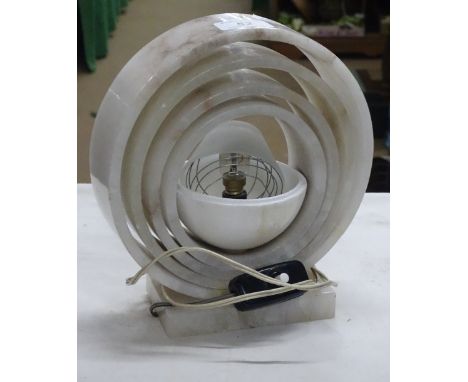 Unusual table lamp formed of stone circles.