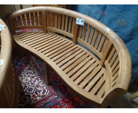 A new Indonesian hardwood bow back garden bench.