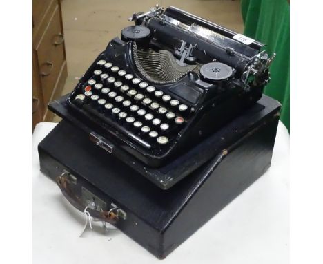 An early German continental portable typewriter with carrying case.