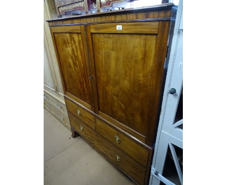 A 19th century mahogany 2-section dwarf linen press, the 2 panelled doors revealing 4 fitted slides with 3-drawers under, sha