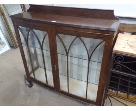 1920s oak bow front 2-door display cabinet, claw and ball feet, width 4'.