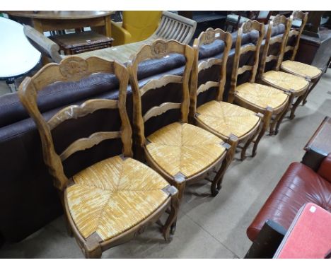 A set of 6 French oak ladder back and rush seated dining chairs.