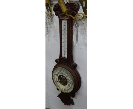 An oak cased aneroid wall barometer with thermometer.