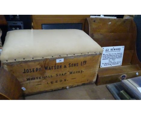 An upholstered stool made from an old pine box, a Mainline brand display stand and a £2 reward notice.