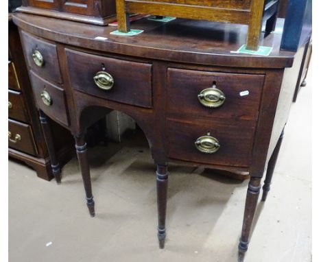 A Georgian mahogany bow front sideboard, with 5 short fitted drawers raised on turned legs, width 3'9", height 3', depth 2'4"