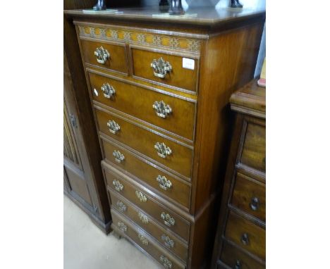 A reproduction mahogany tall boy, with applied carved decoration of ogee bracket feet, width 2'1",height 4'6", depth 1'4".
